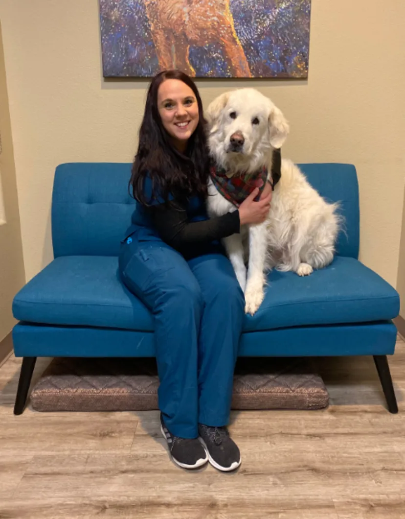 Melissa hugging a white dog